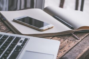 How to Handle Ghosting as a Hypnotherapist Mobile Phone on a book